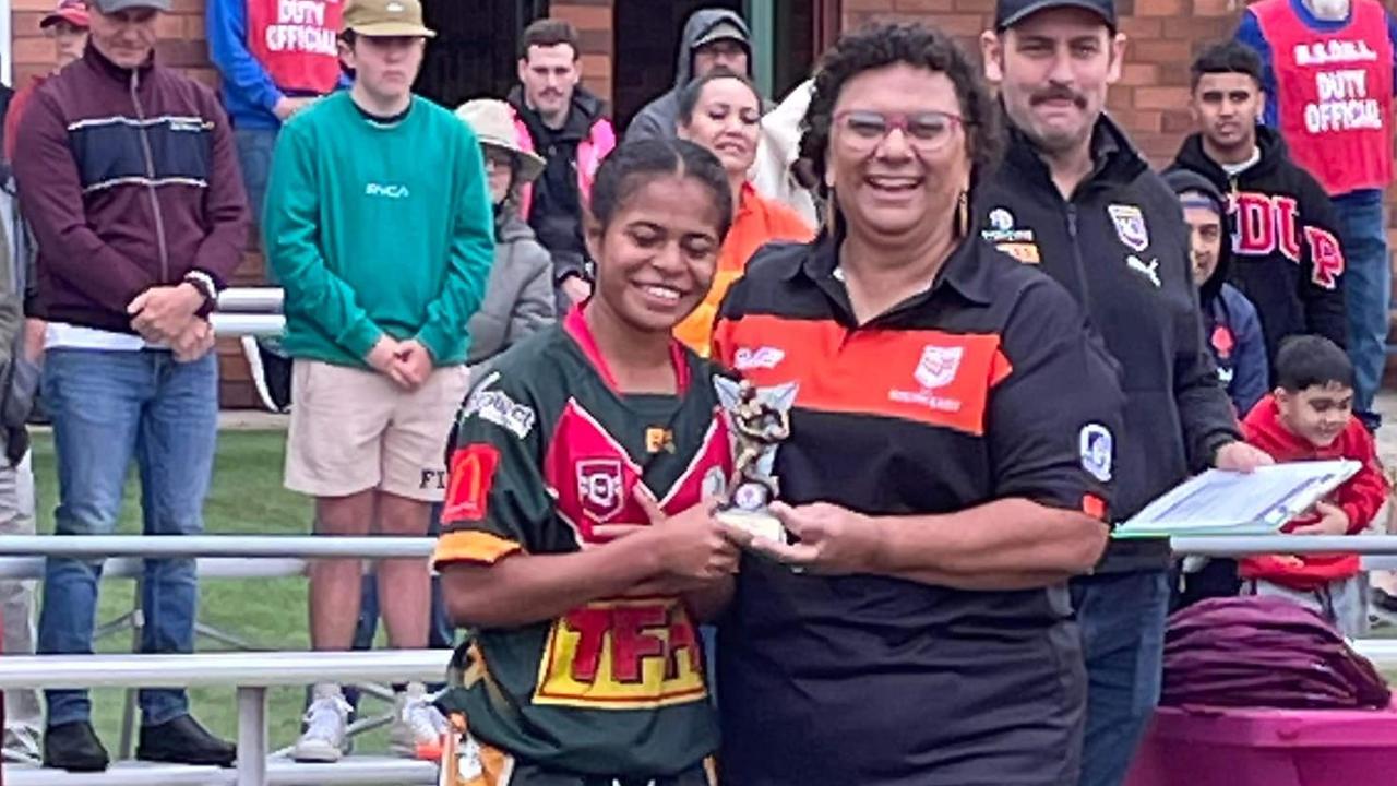 Janique Mii with her award from Logan Brothers.