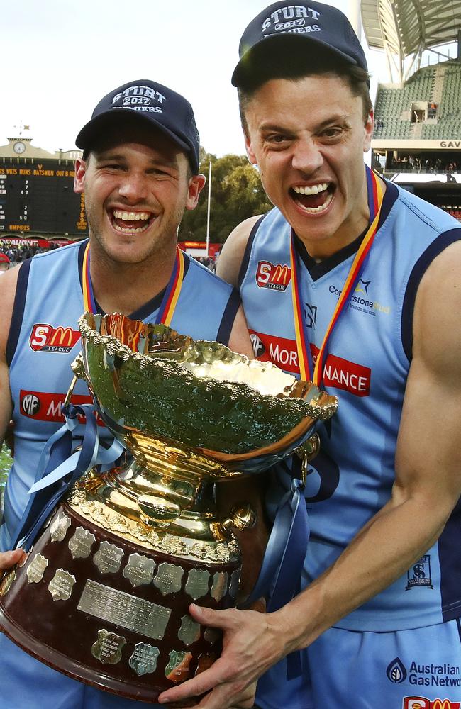 Sturt’s Zane Kirkwood and Jack Stephens celebrate with the trophy. Picture: SARAH REED