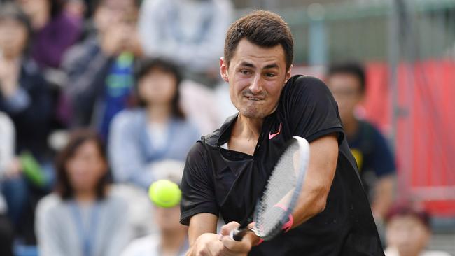 TOKYO, JAPAN — OCTOBER 04: Bernard Tomic of Australia plays a backhand against Diego Schwartzman of Argentina during day three of the Rakuten Open at Ariake Coliseum on October 4, 2017 in Tokyo, Japan. (Photo by Atsushi Tomura/Getty Images)