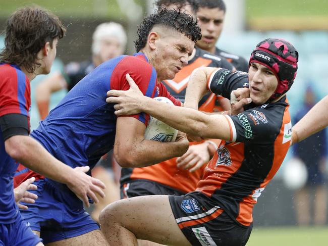 Knights player Navren Willett being tackled during the Balmain Tigers v Newcastle Knights NSWRL Junior Rep Harold Matts Game at Leichhardt Oval today. Picture: Tim Hunter.