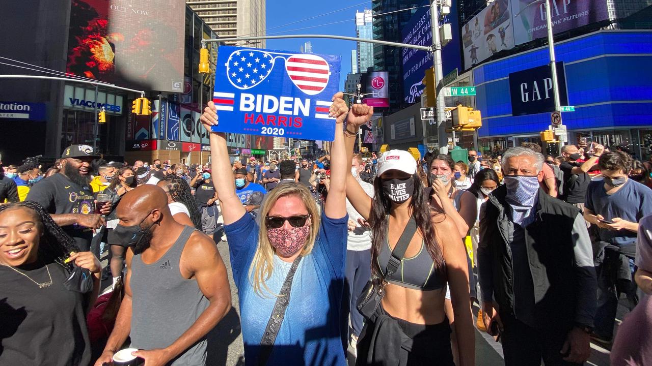 People celebrate at Times Square in New York after Joe Biden was declared winner of the 2020 presidential election. Picture: Kena Betancur/AFP