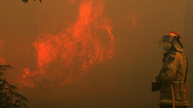 The fire is raging out-of-control along Lemon Tree Passage Rd, in Salt Ash, on Friday morning. Picture: AAP