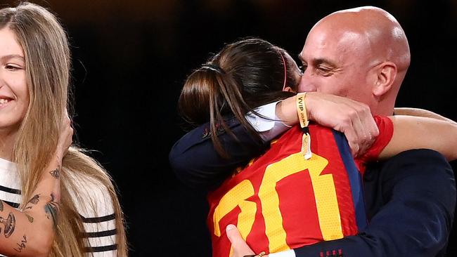 Spain's defender #20 Rocio Galvez is congratuled by President of the Royal Spanish Football Federation Luis Rubiales (R) next to Spain's Jennifer Hermoso after winning the Australia and New Zealand 2023 Women's World Cup final football match between Spain and England at Stadium Australia in Sydney on August 20, 2023. The Spanish football federation (RFEF) on August 26, 2023 threatened to take legal action over Women's World Cup player Jenni Hermoso's "lies" about her kiss with its president Luis Rubiales. (Photo by FRANCK FIFE / AFP)