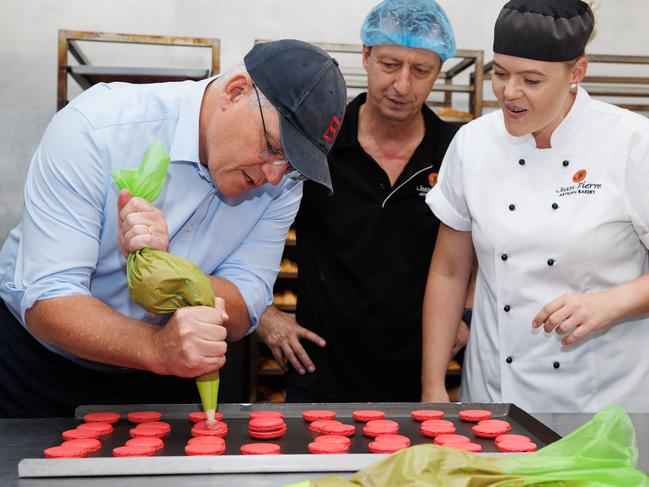 Prime Minister Scott Morrison has a sweet moment at a Townsville bakery on Tuesday. Picture: Jason Edwards