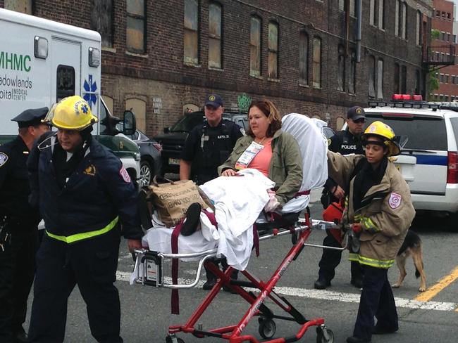 A woman is wheeled away from the Hoboken Terminal train station on a stretcher. Picture: AP Photo/Karen Matthews