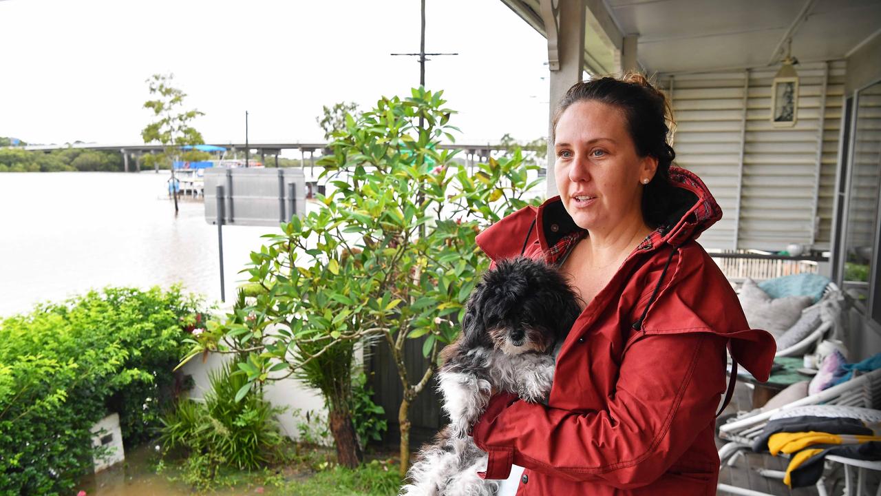 Bradman Ave remains closed as residents prepare for more rain and heavy flooding to hit the Sunshine Coast. Richelle Rae overlooks the flooded Maroochy River. Picture: Patrick Woods.