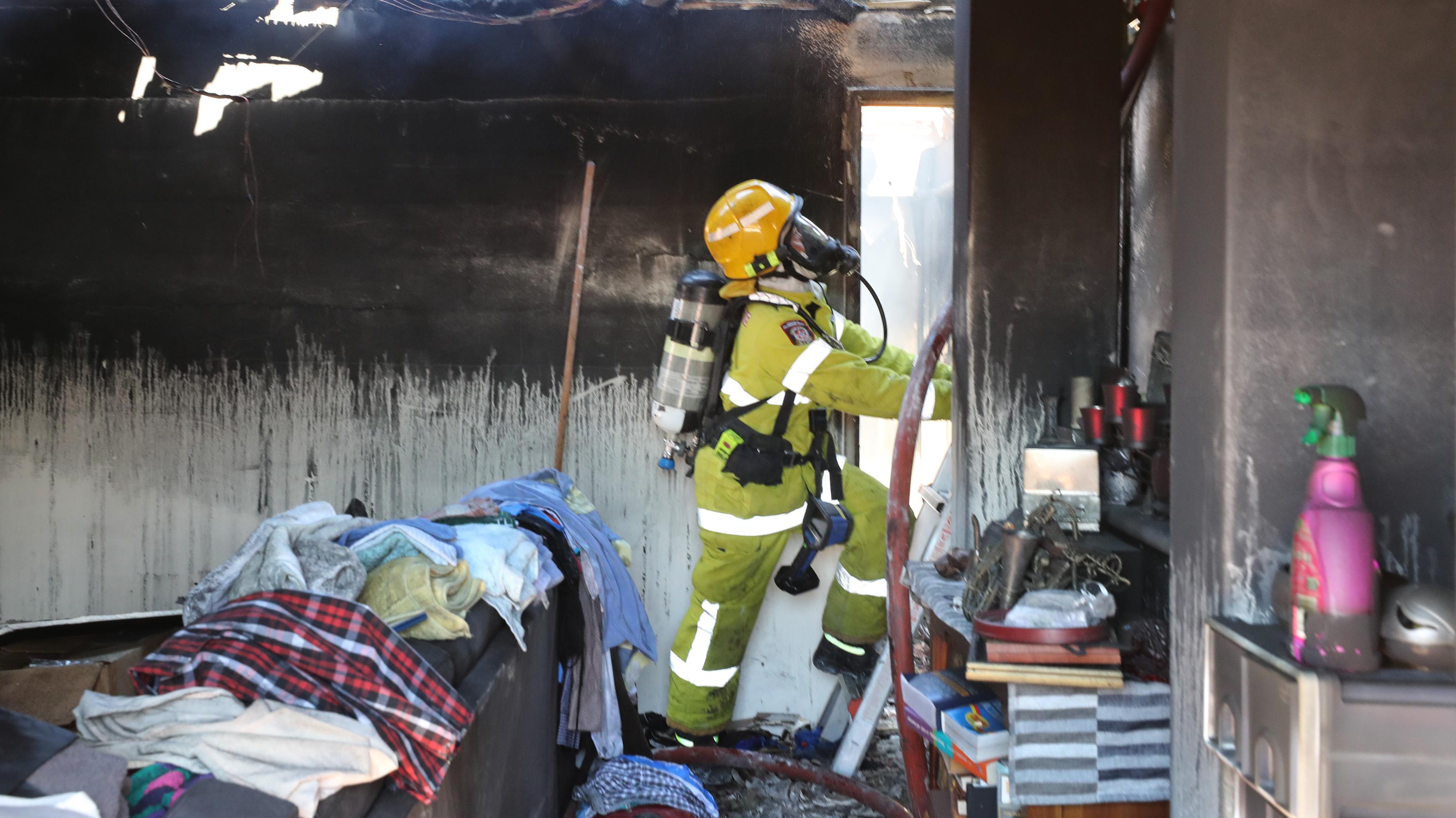 Fire fighters at the scene of a unit fire on the corner of Wanneroo Road and North Beach Road, Tuart Hill.