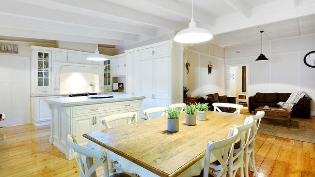 Exposed beams and a classic country-style kitchen add to its charm.