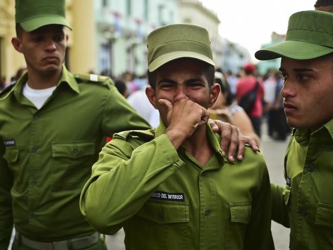 Soldiers cry after the urn with the ashes of Cuban leader Fidel Castro was driven through Santa Clara on December 1, 2016 during its four-day journey across the island for the burial in Santiago de Cuba. Picture: AFP PHOTO / Ronaldo SCHEMIDT