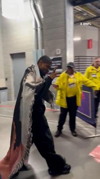 Usher arrives at the Super Bowl all rugged up