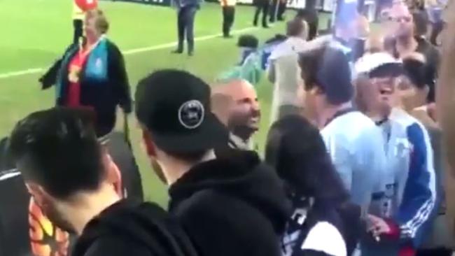 George Calombaris is mocked by a fan at the football.