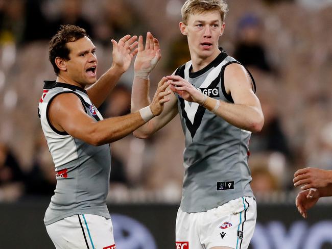 Motlop, with Port Adelaide forward Todd Marshall, played 14 AFL games in 2022. Picture: Dylan Burns/AFL Photos via Getty Images.