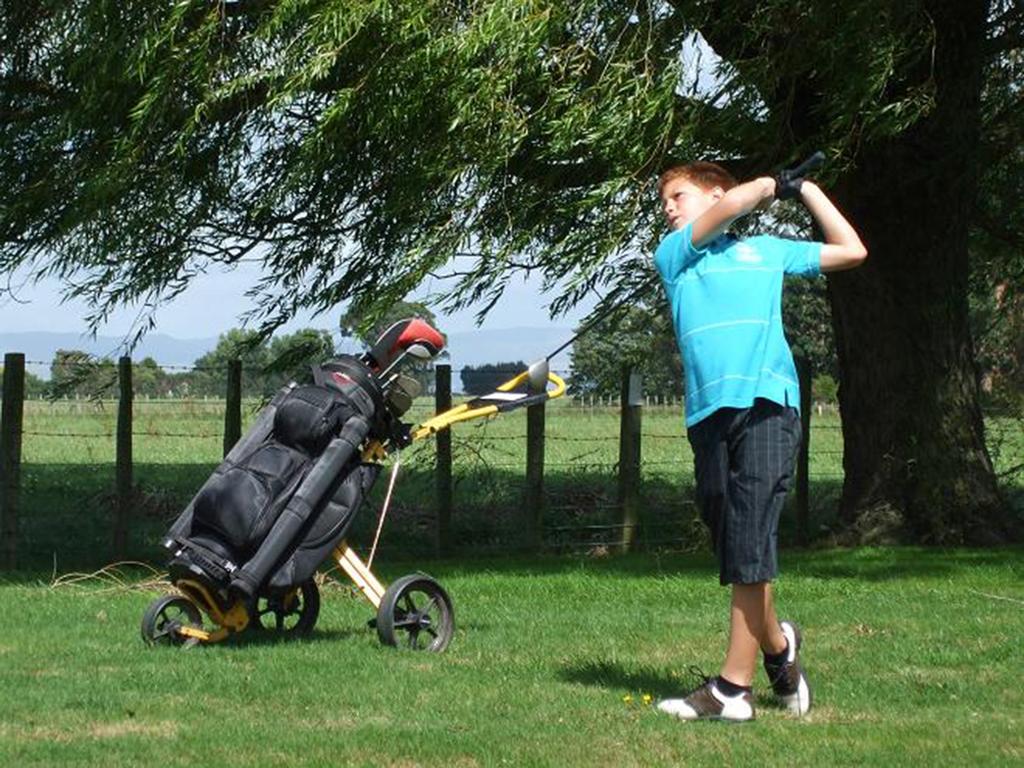 A young Kalyn Ponga playing golf,