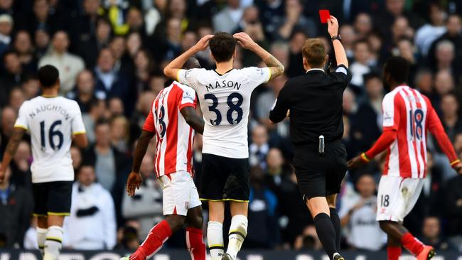 Referee Mike Jones shows the red card to Kyle Naughton #16 (L) of Spurs.