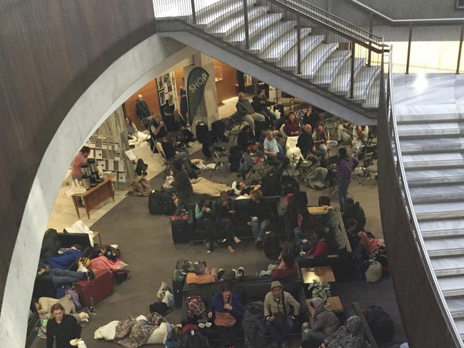 Tourists take shelter in New Zealand’s parliamentary complex in Wellington, after some hotels were evacuated. Picture: AP