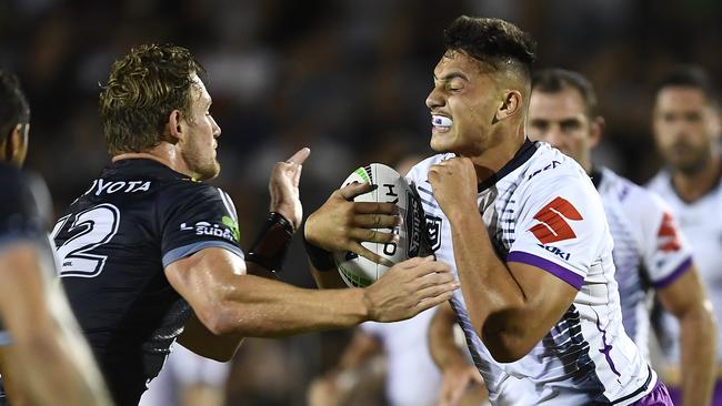 Tino Fa’asuamaleaui runs at North Queensland’s Coen Hess. Picture: Ian Hitchcock/Getty Images