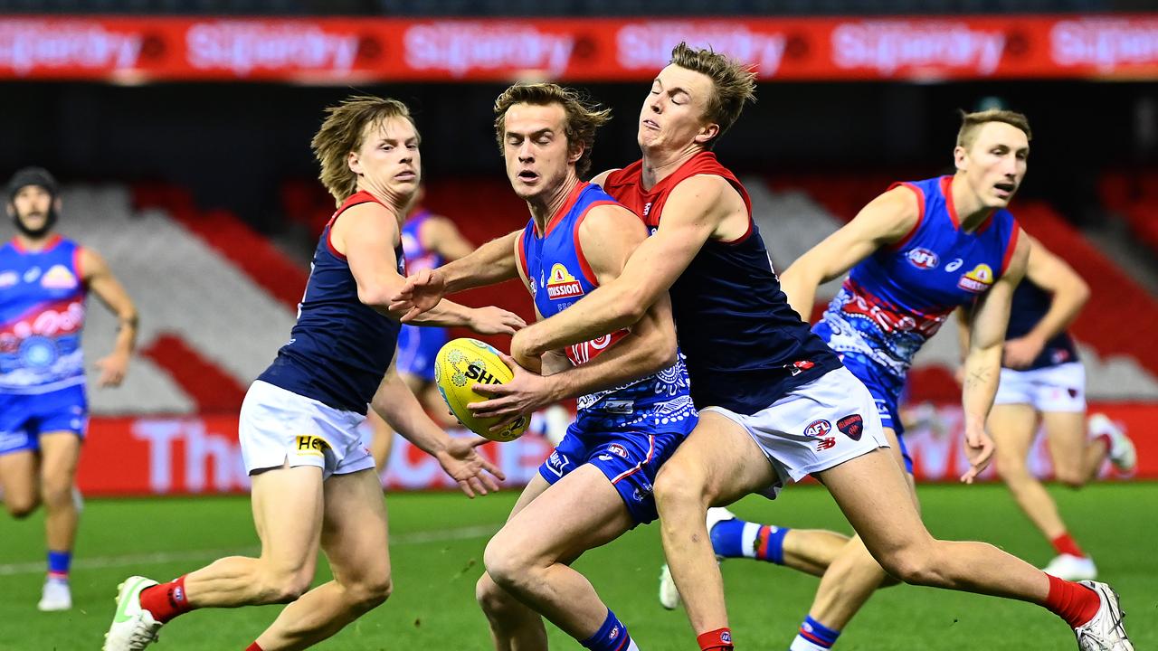 Louis Butler of the Bulldogs is tackled by James Jordan of the Demons. Picture: Quinn Rooney