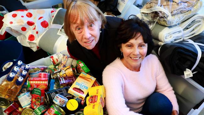 77 year old Heather Stephens and 69 year old Margaret Abel pose for photographs with donated items at Guild Leagues Club. Guildford, Monday, July 16th 2018. Margaret has been a member of the Guild Leagues Club for many years She has spearheaded the campaign at the club to donate items to Youth off the street and Exodus. (AAP Image / Angelo Velardo)