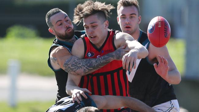 Nick Parks gets sandwiched between Laurimar defenders. Picture: David Crosling