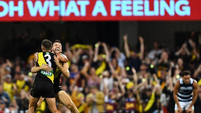 Tiger fans jump to their feet as the siren sounds.