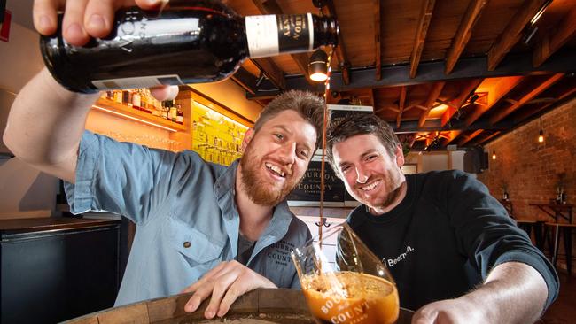 Joe Lusk, from Goose Island brewery, and Shayne Dixon, owner of Beermash bar, with the Bourbon County beer. Picture: Jay Town