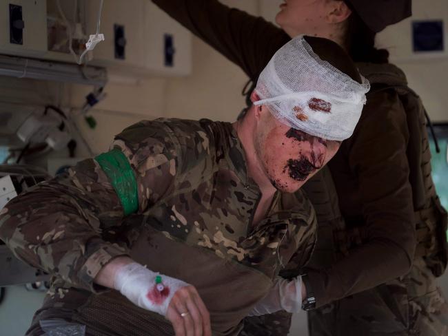 A wounded Ukrainian serviceman receives treatment near Bakhmut, as Wagner group says there are no Ukrainian soldiers left. Picture: AFP