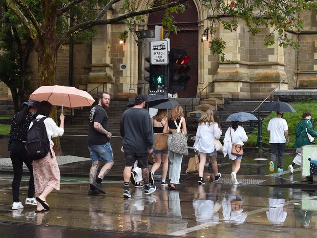 Shoppers get caught in heavy rain. Picture: Nicki Connolly