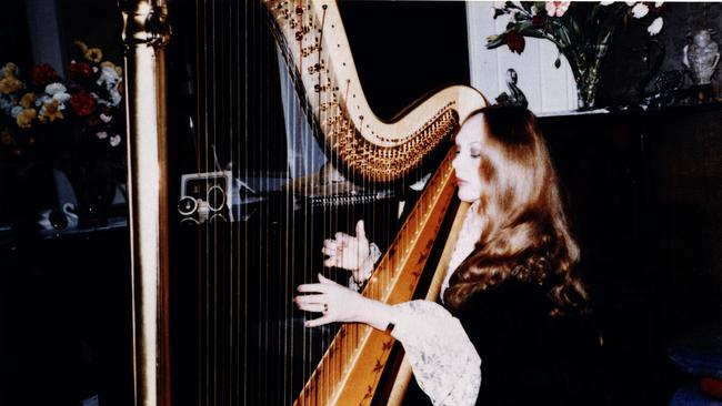 Hamilton-Byrne plays the harp for followers in the early days of The family.