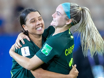 GRENOBLE, FRANCE June 18. Sam Kerr #20 of Australia, after scoring four goals, celebrates with teammate Ellie Carpenter #21 of Australia at the end of the game during the Jamaica V Australia, Group C match at the FIFA Women's World Cup at Stade des Alpes on June 18th 2019 in Grenoble, France. (Photo by Tim Clayton/Corbis via Getty Images)