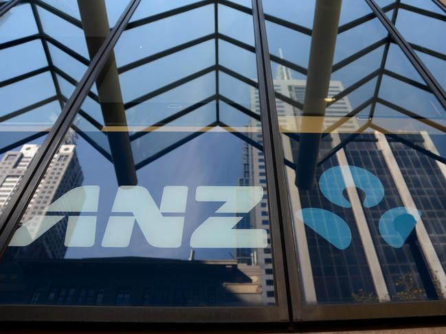 City buildings are reflected in an ANZ sign on the exterior of an inner city ANZ branch in Melbourne, Australia on Tuesday, Apr. 30, 2013. Photographer: Carla Gottgens/Bloomberg