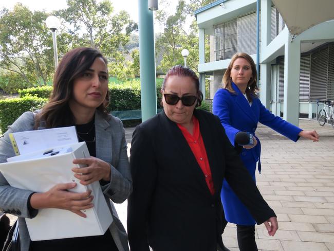 Maria Virgili (red shirt, black suit) arrives at Gosford District Court at an earlier appearance. Picture: Richard Noone