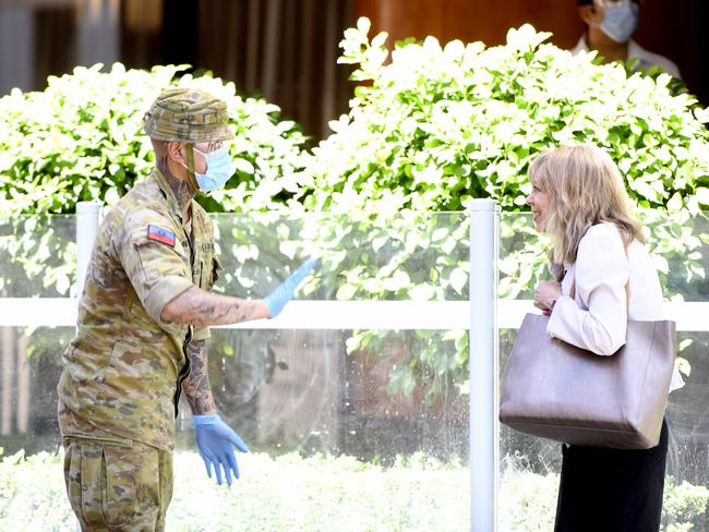 ADELAIDE, AUSTRALIA - NewsWire Photos - NOVEMBER 25, 2020 - A military personnel blocks a pedestrian at Peppers Waymouth Street Hotel in the CBD where the Parafield cluster originated. Picture: NCA NewsWire / Naomi Jellicoe