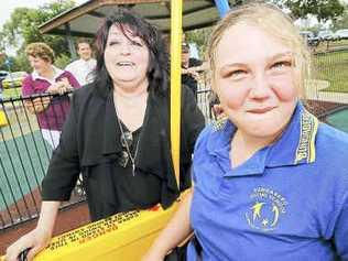 Cr Mary Wilkinson celebrates with Bundaberg Special School student Skye Sellars, the first person to use the new liberty swing at Lake Ellen Heritage Hub. Picture: Max Fleet