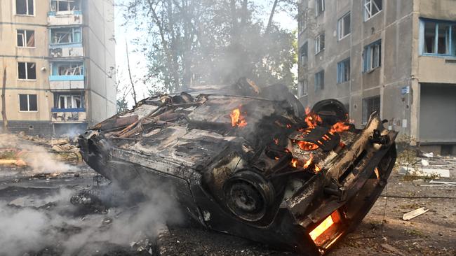 A burnt-out car is seen in the courtyard of a damaged residential building following a missile attack in Kharkiv on August 30. Picture: AFP