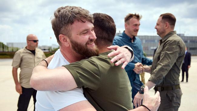 Volodymyr Zelensky embraces Svyatoslav Palamar on his return. Picture: Ukrainian Presidential Press Service via AFP