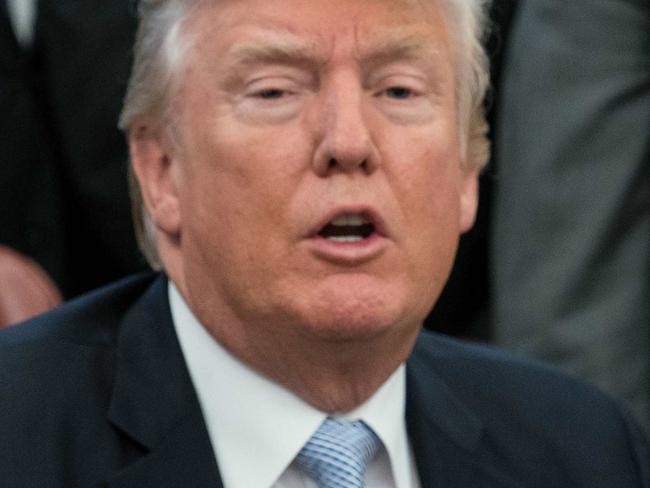 US President Donald Trump speaks to the press after signing a proclamation calling for a national day of prayer on September 3 for those affected by Hurricane Harvey in the Oval Office at the White House in Washington, DC, on September 1, 2017. / AFP PHOTO / NICHOLAS KAMM