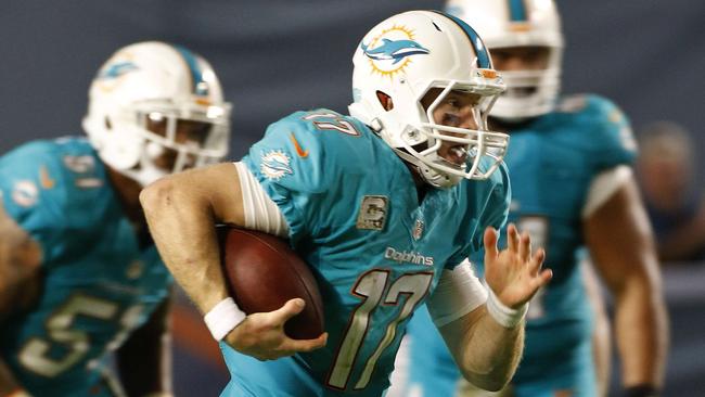 Quarterback Ryan Tannehill #17 of the Miami Dolphins runs for yardage.