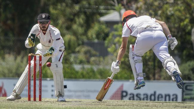 South Caulfield keeper Elliott Bradley and Mordialloc batter Ryan Morris. Picture: Valeriu Campan