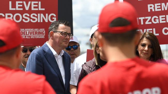 Victorian Premier Daniel Andrews (second left) and Marlene Kairouz (right) are seen with Labor party supporters wearing red shirts at Deer Park train station in Melbourne in 2018.