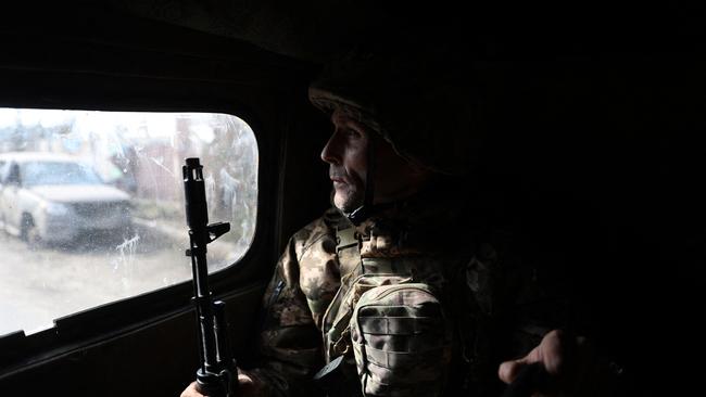 A Ukrainian serviceman looks on as he rides in a vehicle in Bakhmut. Picture: Anatolii Stepanov / AFP