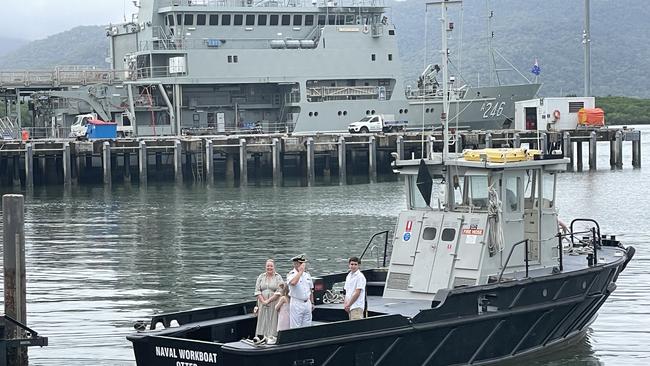 Outgoing HMAS Cairns Commanding Officer Alfonso Santos is saluted during the handover ceremony accompanied by his wife and children. Photo: Dylan Nicholson