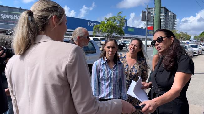 Jessica Blinda Polsoni Hanbury (striped shirt) and Heidi Ward (black dress) confront media outside Mackay court house. Picture: Fergus Gregg