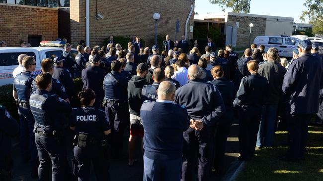 Police gather outside the Yamanto station.