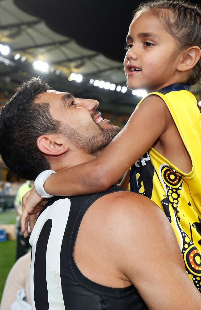 Pickett celebrates with his daughter after the match. Picture: AFL Photos/Getty Images