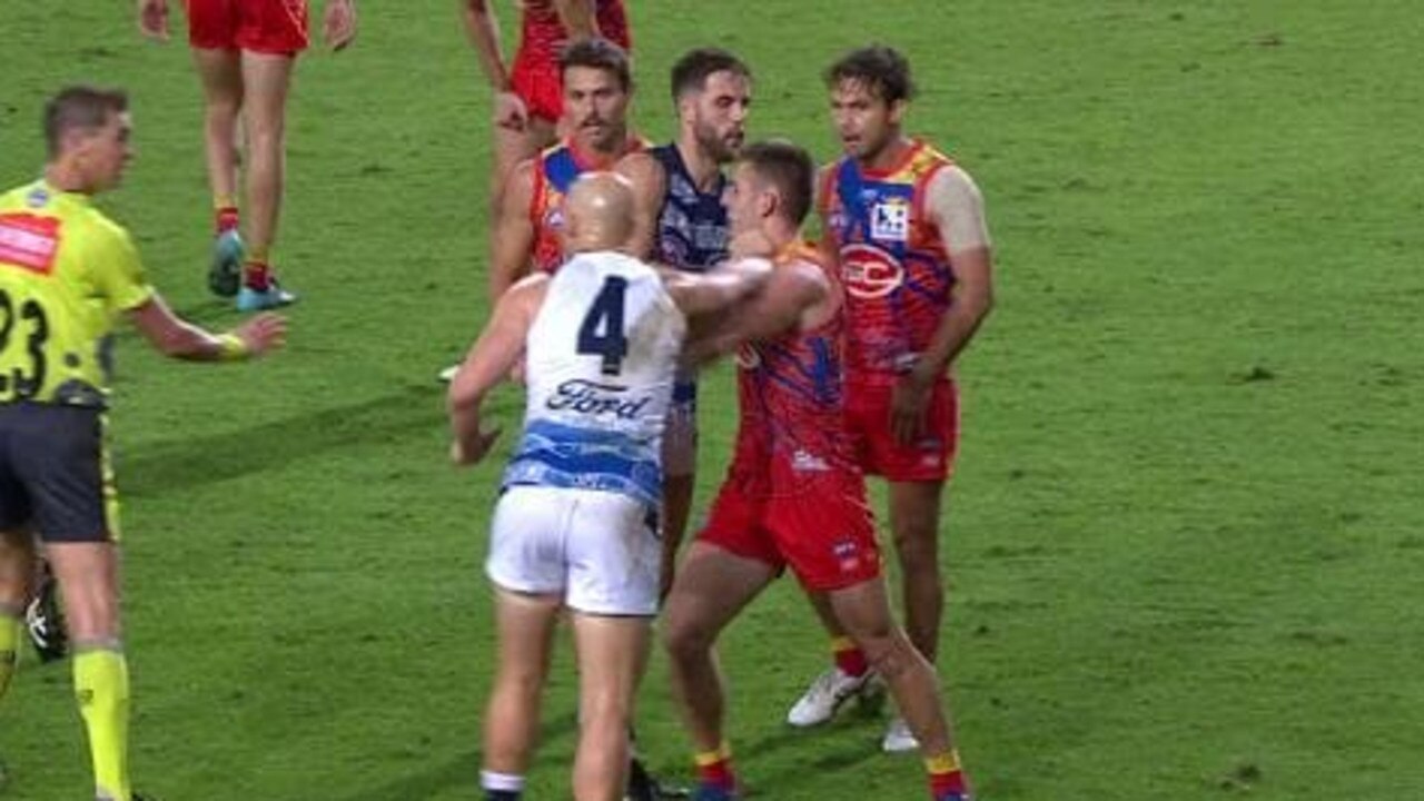 Gary Ablett throws a right hook at Anthony Miles.