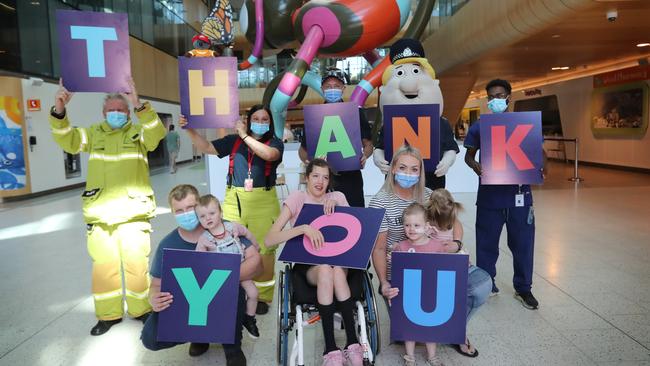 Geoff Stewart and Stacey Sorrell (from CFA Bayswater), Sergeant Alex Wallace with Sergeant ‘Pete’ and RCH staff Tom Gebreselassie and Tom Pender holding Max, 18 months, Bryanna Shaw, 19, and Shauni Pender holding Annie, 3 and Nellie, 18 months. Picture: Alex Coppel