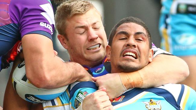 Titan Nene Macdonald is tackled by Storm’s Ryan Hinchcliffe in round 22.