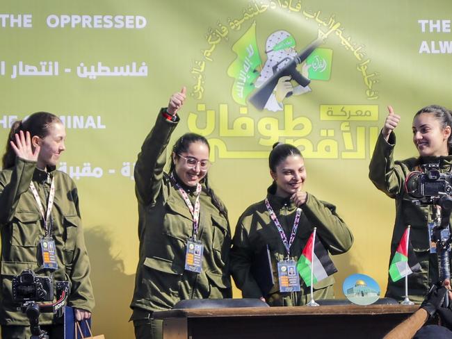 Israeli female soldier hostages Naama Levy, Daniella Gilboa, Karina Ariev and Liri Albag, in no particular order, salute a Palestinian crowd before being handed over to the Red Cross in Gaza City, Saturday, Jan. 25, 2025. (AP Photo/Abed Hajjar)