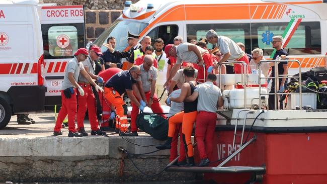 Rescuers bring a body bag back to shore after the super yacht sunk. Picture: Twitter/X