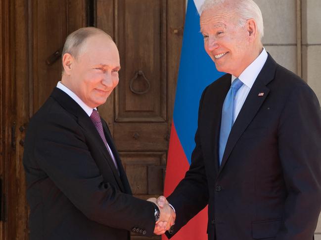 US President Joe Biden (R) and Russian President Vladimir Putin shake hands as they arrive at Villa La Grange in Geneva, for the start of their summit on June 16, 2021. (Photo by SAUL LOEB / POOL / AFP)